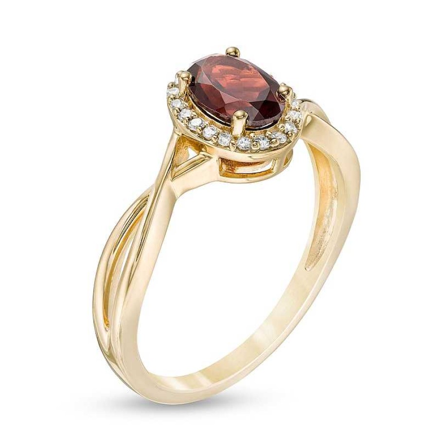 Rings Zales | Oval Garnet And 1/15 Ct. T.W. Diamond Frame Twist Shank Ring In 10K Gold